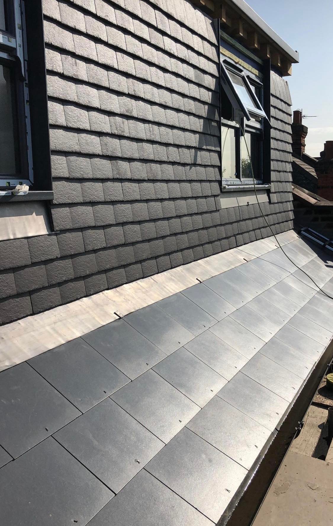 New lead flashing and tiles installed on a roof