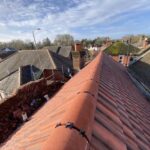 An aerial view of a new roof with red tiles.
