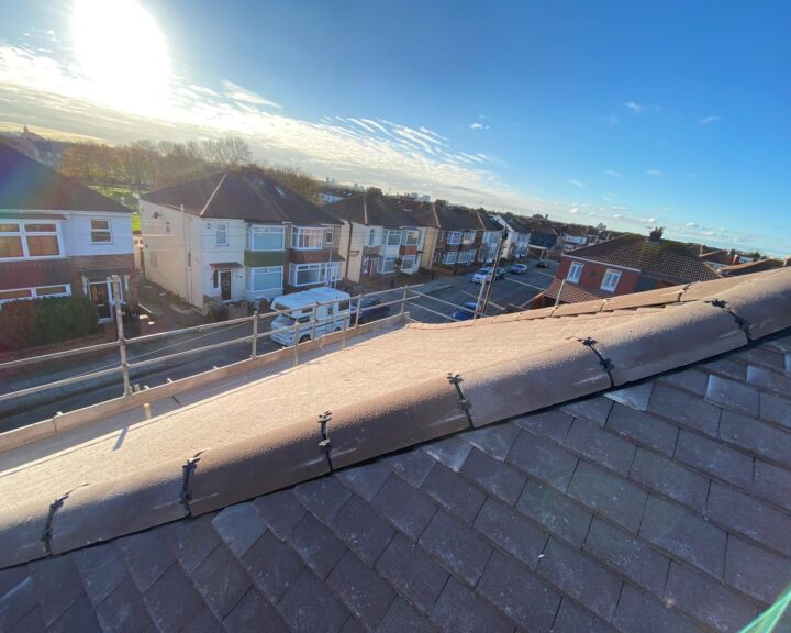 A view of a roofer repairing a roof in Birmingham.