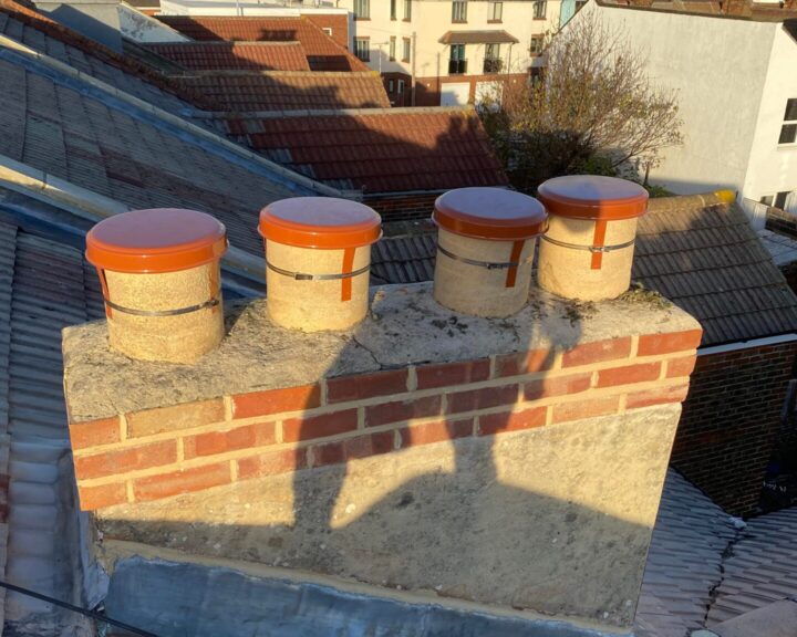 A brick chimney on a new roof.